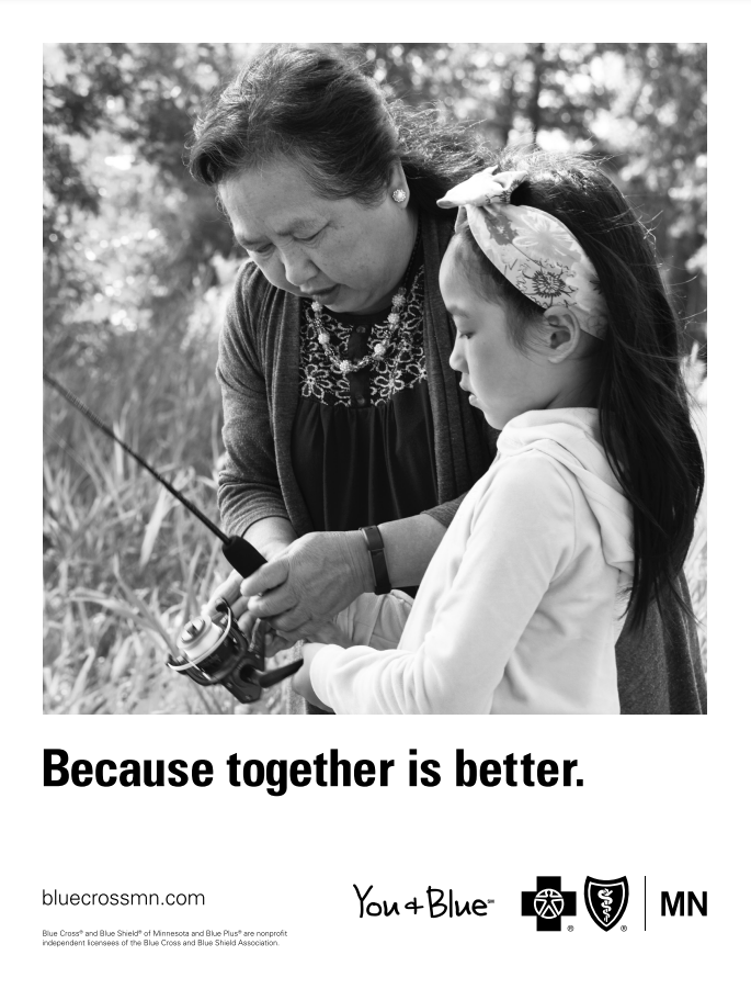 Hmong grandmother helps her granddaughter wind a fishing line in nature. Because together is better. You & Blue: Blue Cross Blue Shield of Minnesota.